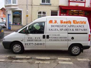 An earlier M J Booth Electric van, lettered Domestic appliance sales, spares and repairs, cookers, tumble dryers, washing machines